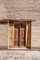 old crooked door in an old wall