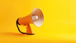 un mégaphone sur fond jaune pour faire porter sa voix