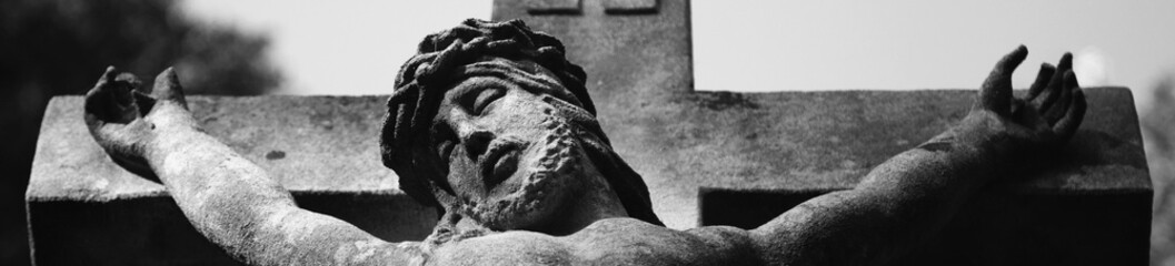 Wall Mural - Suffering and death of Jesus Christ. View from the bottom of the ancient statue. Black and white image.