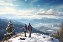 A Couple Stand Together At Snow Covered Mountain Top With Forest With A Great Visa View. Winter Seasonal Concept.