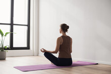 Young Woman Practicing Yoga Near Floor Window In Yoga Studio, Young Girl Meditating At Home, Harmony, Balance, Meditation, Relaxation, Healthy Lifestyle Concept