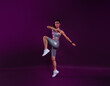 © Artem Varnitsin - Full length of slim healthy woman warming up over a magenta background, wearing silver fitness attire