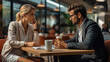 © visoot - Two business people at a coffee shop discussing strategy.