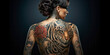Tattooed woman with a tiger tattoo on her back