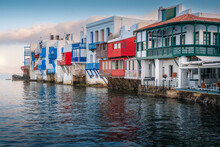 A Stunning Mykonos Vista: White Houses Against A Breathtaking Sea Backdrop, A Picture Of Greek Island Paradise.