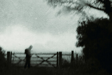 Wall Mural - A spooky mysterious ghostly figure On a bleak winters day. in the countryside. With an abstract, grunge, blurred edit.