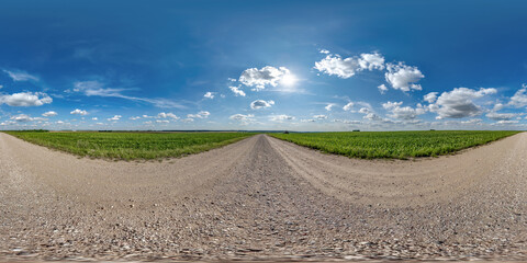 Wall Mural - 360 hdri panorama on gravel road with marks from car or tractor tires with clouds on blue sky in equ