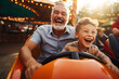 © Néstor - Grandparent and grandson enjoying driving a bumper car