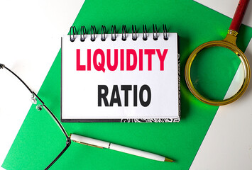 Poster - LIQUIDITY RATIO text on notebook on green paper