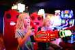 Little Kids Playing Shooting Game Challenge at Video Arcade
