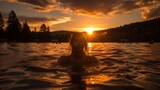 Fototapeta  - girl swimming in the sunset