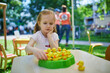 © Ekaterina Pokrovsky - preschooler girl playing board game outdoors