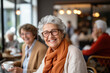 © paffy - Smiling senior woman sitting in cafeteria looking at camera
