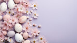 Fototapeta  - creative easter layout. horizontal pattern made with spring flowers and eggs on a pastel lilac background. copy space. top view. flat lay 