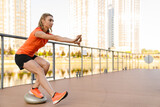 Fototapeta  - Athletic woman doing workout on city bridge