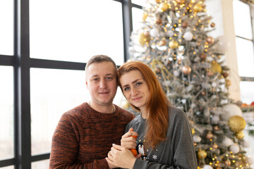 couple near the Christmas tree. the winter vacation. Christmas morning family celebrations