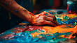 hands of artist paints with brushes on the table