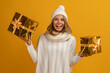 © mary_markevich - young smiling woman holding golden present boxes celebrating new year, christmas gifts