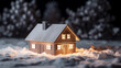 Makieta domku w śnieżnej scenerii, jasno oświetlony noc w tle.