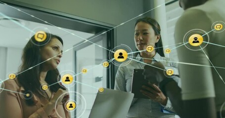 Poster - Animation of connected icons over diverse female coworkers discussing reports in office