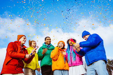 Multiracial group of young friends meeting outdoors in winter - Multiethnic students with colorful winter jackets and stylish outfits having fun in the city