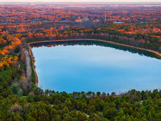 Wall Mural - Fall colors surrounding a lake from an aerial view