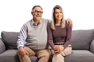 Poster - Father and daughter sitting on a sofa and posing