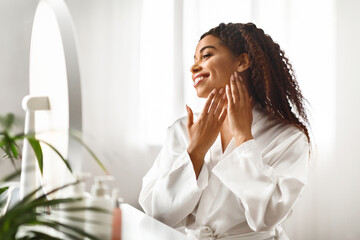 Canvas Print - Beautiful African American Woman Looking In Mirror At Her Soft Smooth Skin