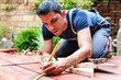 © Aleksandar - Young man building a backyard deck