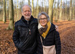 Active senior couple walking in autumn forest