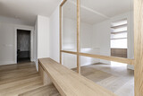Fototapeta  - Distributor hallway of a modern home with a long white oak wood bench and a glass and wood screen