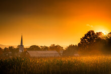 Sunburst Over A Church And Farm In Vermont