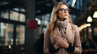 © AS Photo Family - Attractive young elegant fashionable blonde woman in glasses and coat walking in the city.