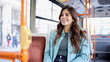 © PeopleVideos - Happy young Latina woman in public transportation