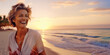 Attractive laughing beautiful caucasian senior mature woman posing at the beach looking away