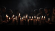 International Holocaust Remembrance Day. Burning candles on dark surface by human beings   