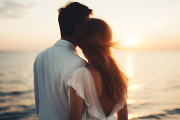 Couple embracing by the sea at sunset.