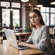 © StellarK - young woman working on laptop with computer in cafe at table