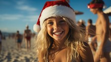 Happy Young Blonde Hair Girl In Red Swimwear And Santa Hat On The Sandy Beach