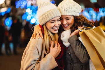 Wall Mural - Sale, shopping, tourism and happy people concept. Beautiful females with shopping bags in the city