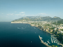Aerial View Of Sailing Boat Along The Coast In Sorrento Bay Near The Harbour, Naples, Campania, Italy.