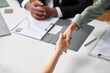 © DragonImages - Company managers greeting new employee, shaking her hand