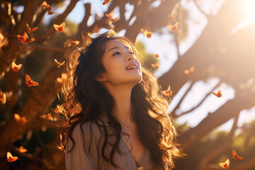 Wall Mural - Happy asian woman excited looking up in the butterflies