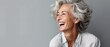 © DZMITRY - Beautiful gorgeous 50s mid age beautiful elderly senior model woman with grey hair laughing and smiling. Mature old lady close up portrait. Healthy face skin care beauty, skincare cosmetics, dental
