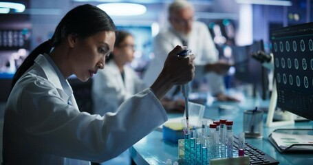 Leinwandbilder - Biotechnology Research Laboratory: Two Caucasian Doctors Discussing CT Brain Scan On Computer. Focus Shifting to Female Asian Scientist Working With Test Tubes To Study Innovative Alzheimer's Medicine