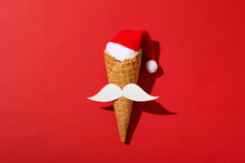 An Ice Cream Cone With A Mustache And A Santa Hat