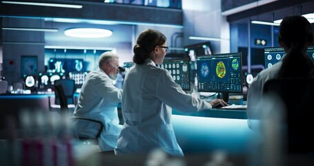 Poster - Back View Of Diverse Scientists Working In Medical Research Center. Male Doctor Using Microscope And His Female Colleagues Looking At MRI Brain Scans On Desktop Computers. Biotechnology Lab Concept.