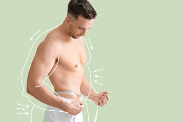 Wall Mural - Muscled young man after weight loss measuring his waist on green background