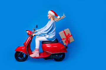 Sticker - Full body profile photo of happy woman motorbike hurry last delivery before fairy midnight new year gift isolated on blue color background