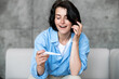 © brizmaker - Happy excited woman looking at pregnancy test with positive result and smile